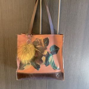 Beautiful floral print leather tote with detachable decorative poof.